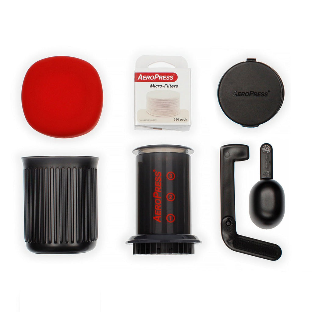 AeroPress Go set with coffee maker, black mug, and red plunger