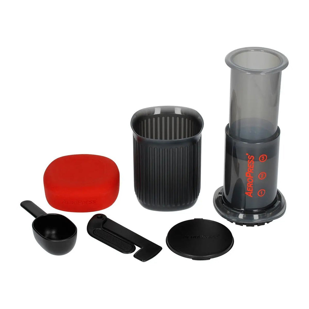 AeroPress Go coffee brewing kit with mug, stirrer, and scoop