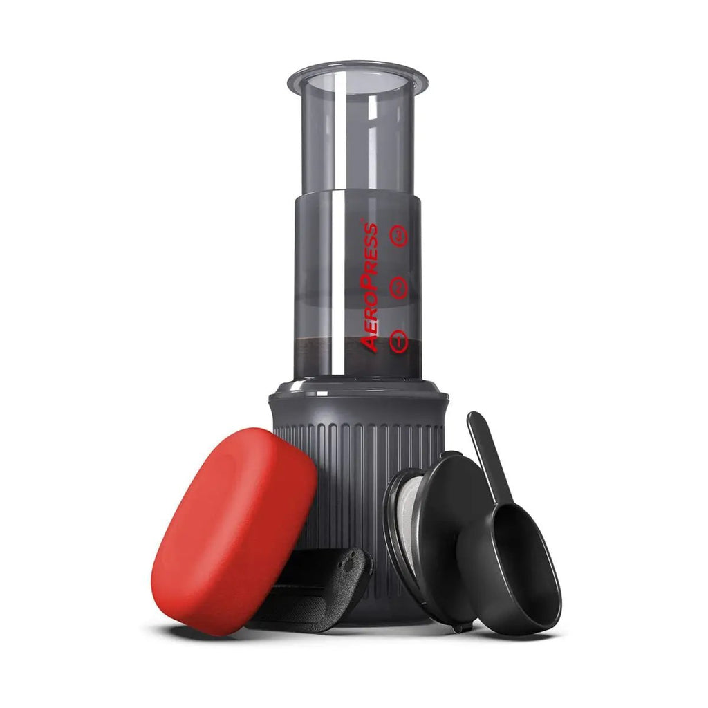 AeroPress Go travel coffee press with red plunger atop black base